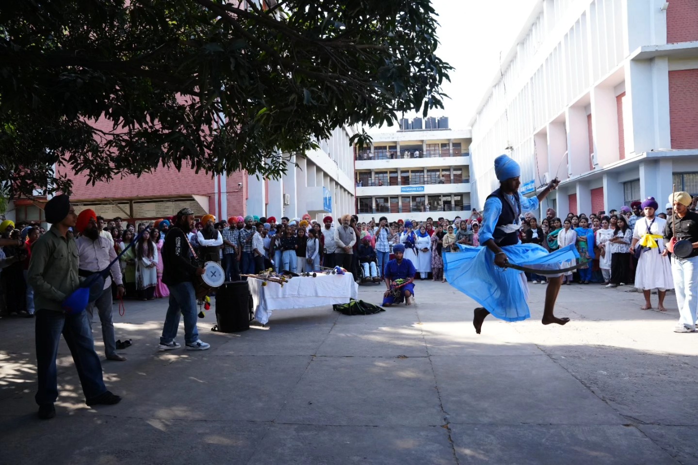 Students perform a dynamic Gatka display during the commemorative programme.